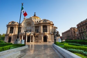 Palace of fine arts facade and Mexican flag on downtown of Mexico capital city