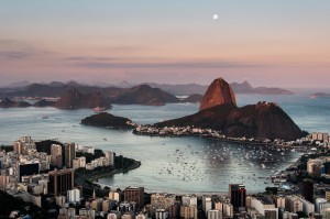 Sugarloaf Mountain and Botafogo Neighborhood in Rio de Janeiro by Sunset with Full Moon in the Sky.
